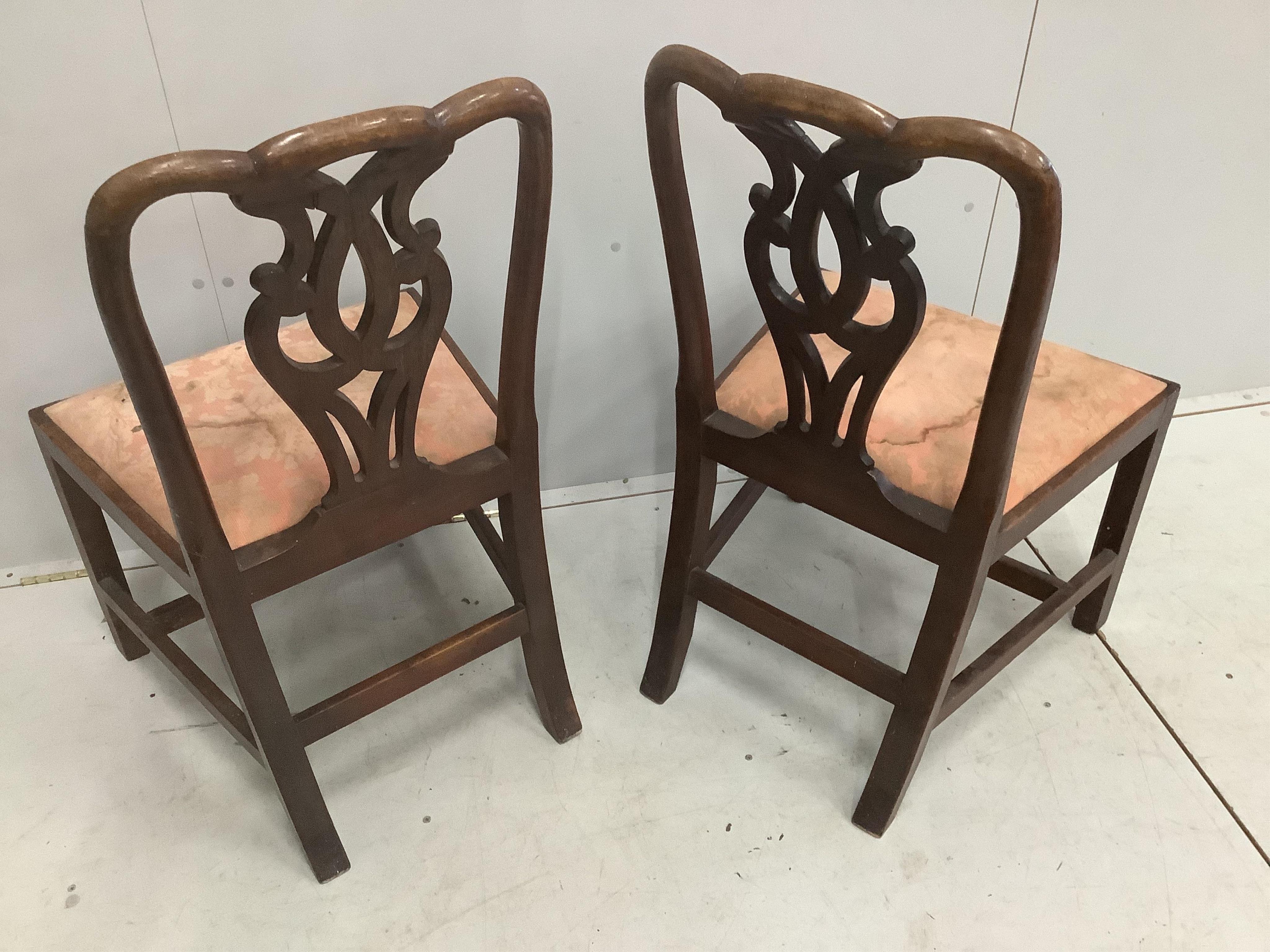 A pair of George III mahogany dining chairs with pierced splat backs, width 54cm, depth 46cm, height 92cm. Condition - fair